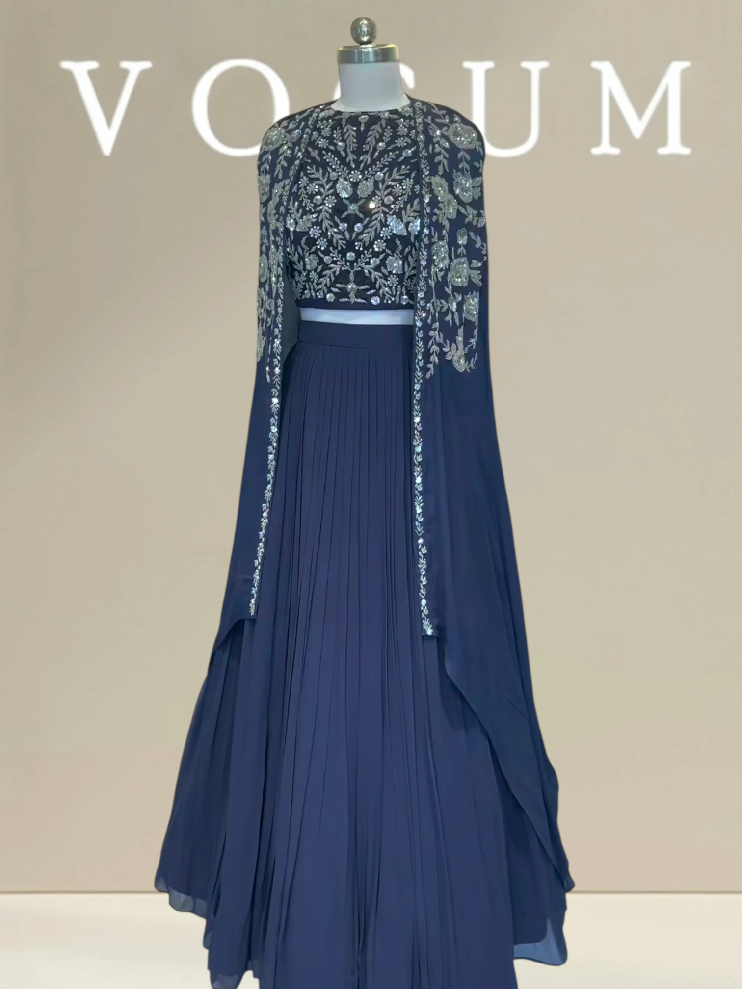 Plated skirt paired with stylish cape related product